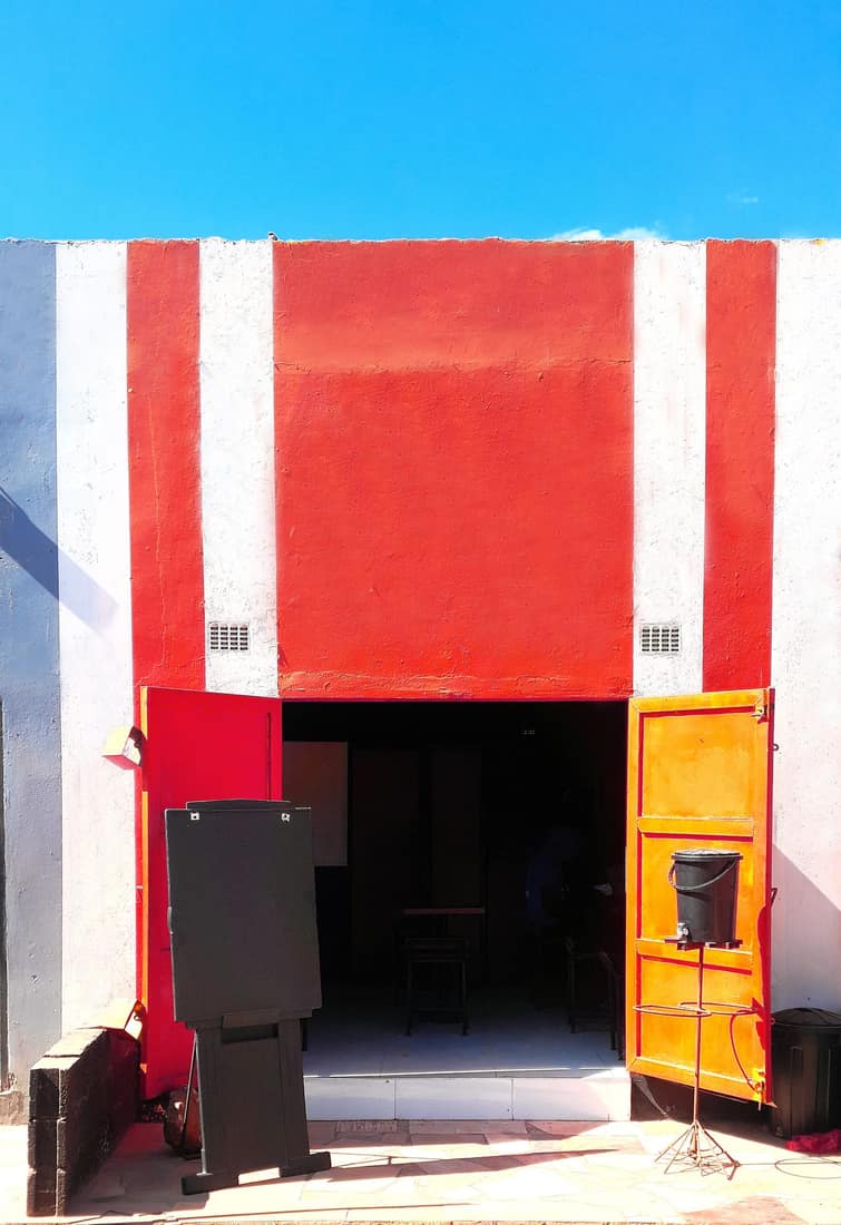The red-and-white Queso Pizza storefront on Great East Road